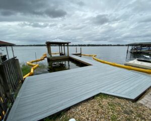 A boat dock with a yellow hose attached to it.