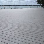 A new wooden deck installation with a view of a body of water.