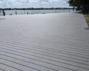 A new wooden deck installation with a view of a body of water.