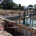 A boat dock and seawall is being built in the water.