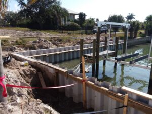 A boat dock and seawall is being built in the water.