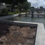 A dock and seawall is being built next to a body of water.