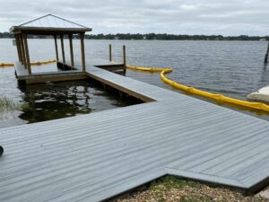 A new custom boat dock installation with a yellow hose attached to it.