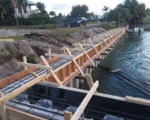 A concrete seawall is being built in the water.