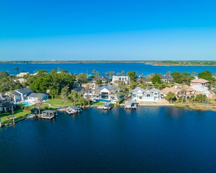 An aerial view of a house on the water within Bay Hill, Orlando FL.