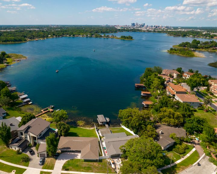 An aerial view of waterfront residential properties on Lake Holden in Orlando, FL.