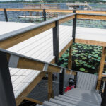 A stairway leading to a wooden deck with water lilies.