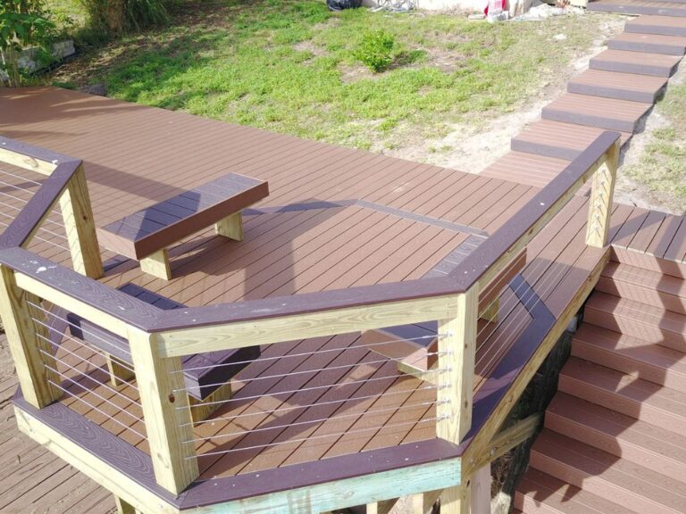 A wooden deck with stairs and a bench, perfect for Seawalls Orlando.