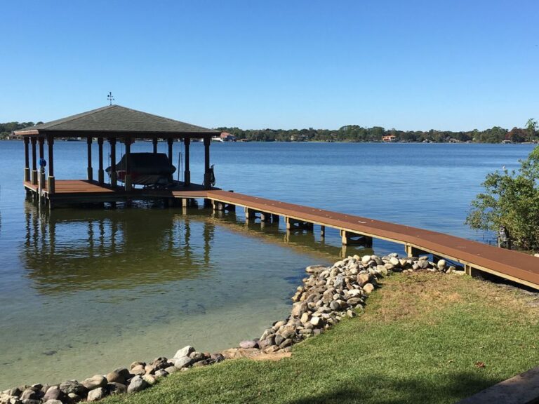 A wooden dock on a lake with a gazebo in Orlando.