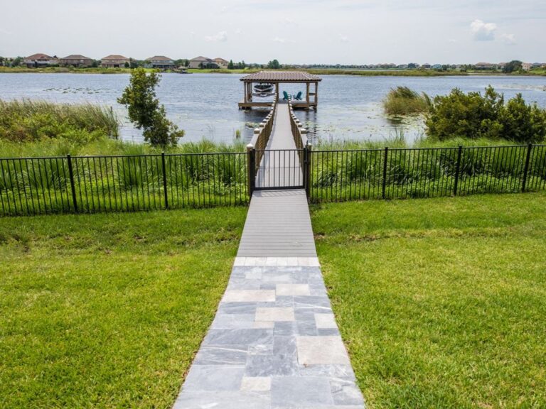 A walkway leading to a dock on a lake, featuring a seamless connection between the land and water.