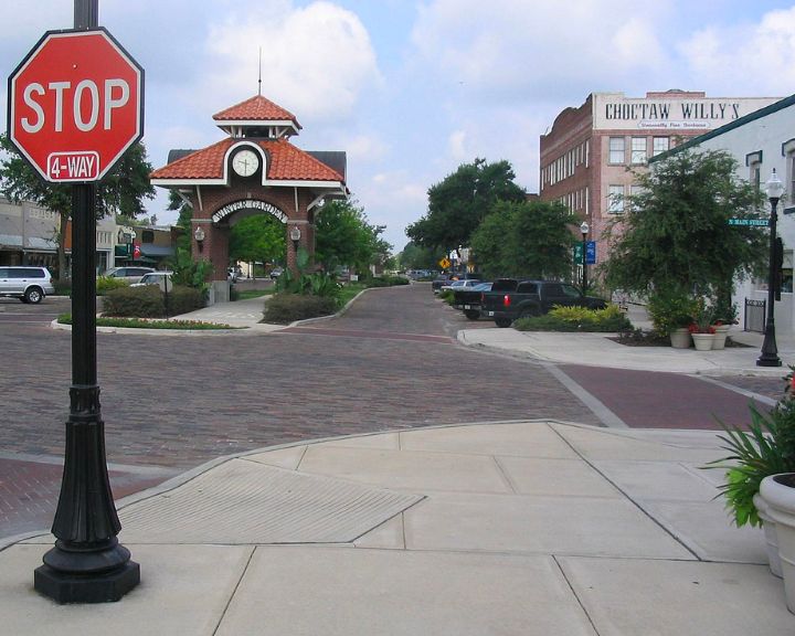 A brick sidewalk in a service area with a stop sign.